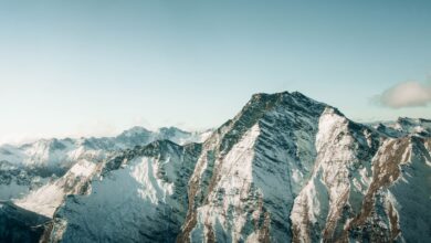 Aerial view of snow-covered mountains in Queenstown, New Zealand, showcasing breathtaking winter scenery.