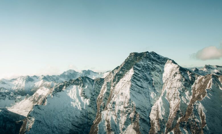 Aerial view of snow-covered mountains in Queenstown, New Zealand, showcasing breathtaking winter scenery.