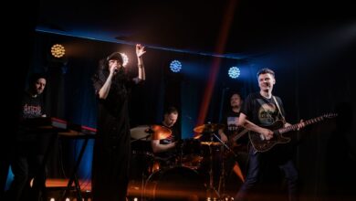 Dynamic live music performance featuring a rock band with singer and instruments on stage.
