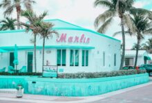 Explore the vibrant Art Deco architecture of Marlin Hotel in Hollywood, FL, with palm trees and a pastel palette.