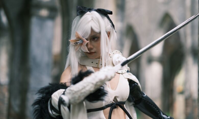A striking image of a cosplayer in gothic attire wielding a sword in a historical setting in Vietnam.