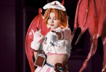 Cosplayer in a demon-themed costume with red wings, posing dramatically. Perfect for fantasy and cosplay themes.