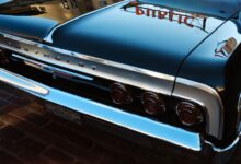 A classic Chevrolet car with mirror-like reflections captures the vintage essence against Seattle's urban backdrop.