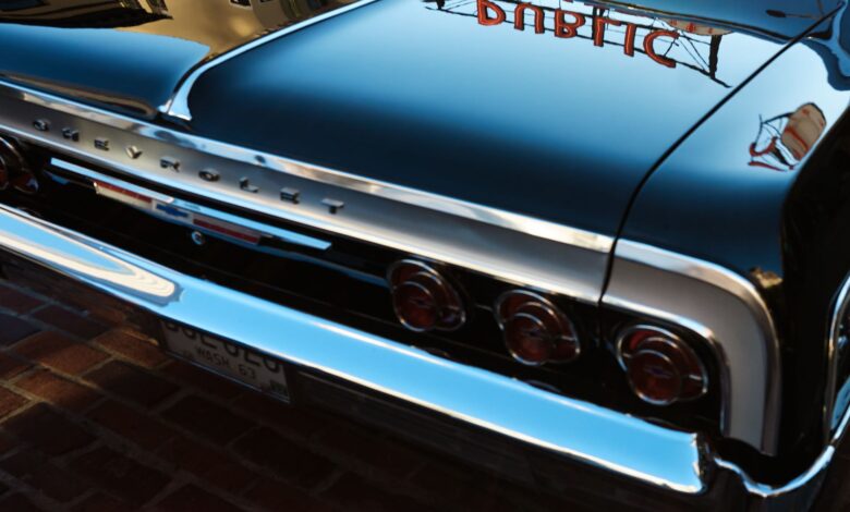 A classic Chevrolet car with mirror-like reflections captures the vintage essence against Seattle's urban backdrop.