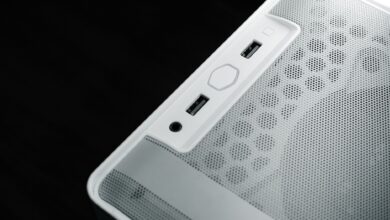 Detailed view of USB and audio ports on a white computer case, showcasing modern technology design.