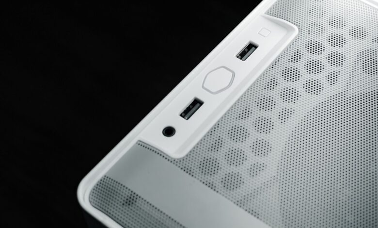 Detailed view of USB and audio ports on a white computer case, showcasing modern technology design.