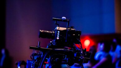A high-quality camera setup capturing a live studio event with an audience in the background.