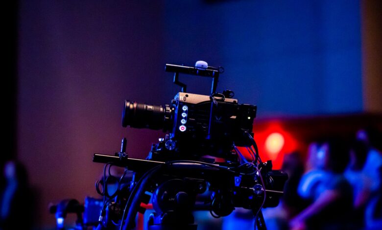 A high-quality camera setup capturing a live studio event with an audience in the background.
