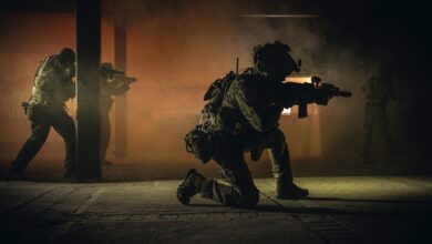 Four soldiers in tactical gear engage in a smoky nighttime military operation indoors.