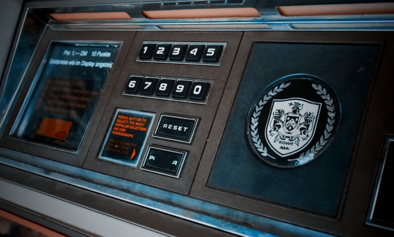 Close-up of a vintage arcade machine control panel with numeric keypad and emblem.