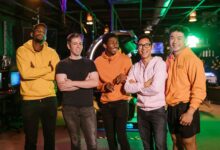 A diverse group of friends having fun and bonding at an arcade, showcasing friendship and joy.