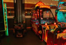 Colorful neon-lit arcade room featuring classic and modern game machines for fun and entertainment.