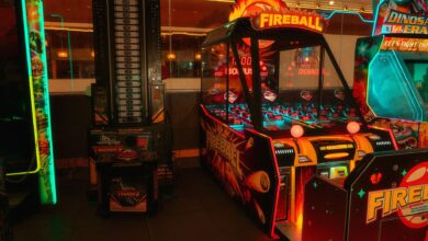Colorful neon-lit arcade room featuring classic and modern game machines for fun and entertainment.
