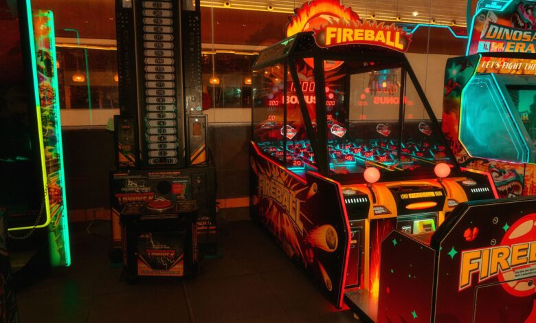 Colorful neon-lit arcade room featuring classic and modern game machines for fun and entertainment.