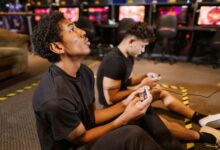 Two teenagers deeply engaged in a video gaming session at an indoor arcade.