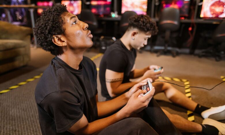 Two teenagers deeply engaged in a video gaming session at an indoor arcade.