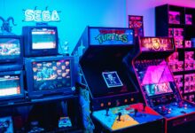 A vibrant retro arcade room featuring classic gaming machines and colorful neon lighting.