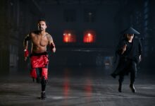 Two men in cosplay costumes running indoors, capturing a dramatic and intense scene.