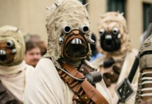A group of people in detailed Star Wars cosplay costumes attending an outdoor event.