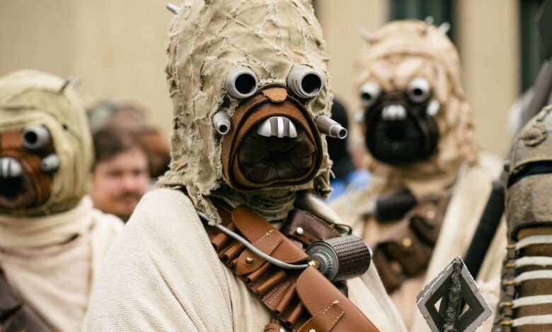 A group of people in detailed Star Wars cosplay costumes attending an outdoor event.