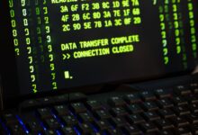Data transfer complete message displayed on a computer monitor with a keyboard underneath.