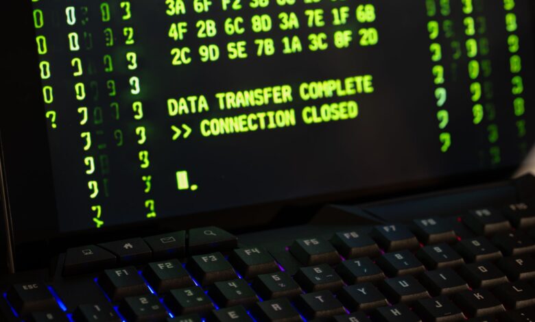 Data transfer complete message displayed on a computer monitor with a keyboard underneath.