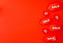 Red sale tags with 50% discounts on vibrant background for retail promotions.