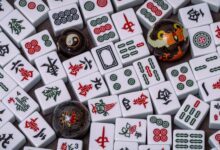 Close-up of traditional Mahjong tiles with Baoding balls, showcasing intricate Chinese symbols and patterns.