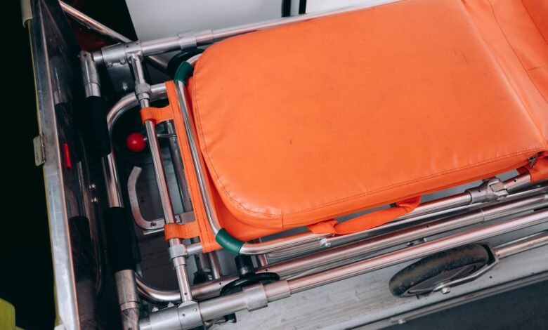 Close-up view of an orange stretcher inside an ambulance, emphasizing medical equipment.