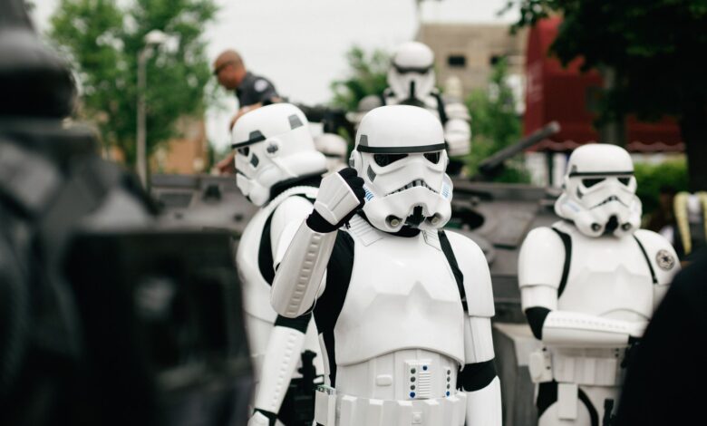 Group of Star Wars stormtrooper cosplayers gathering outdoors during the day.