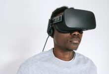 A man using a VR headset, experiencing virtual reality technology indoors.