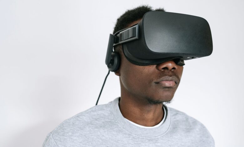A man using a VR headset, experiencing virtual reality technology indoors.