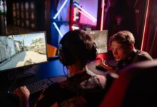 Two gamers engaged in a heated video game session surrounded by neon lights and computer screens.
