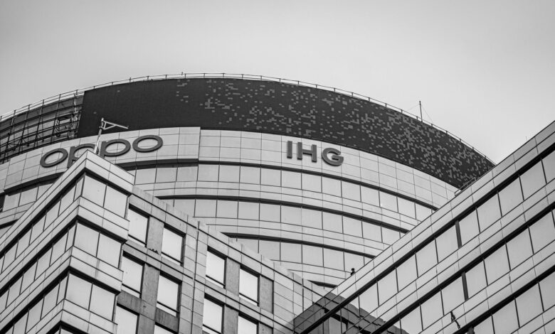 Black and white photo of a modern office building in Gurugram with glass facade and unique architecture.