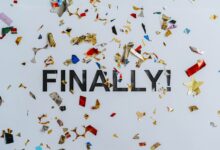 Colorful confetti scattered over the word 'Finally' symbolizing celebration or achievement.