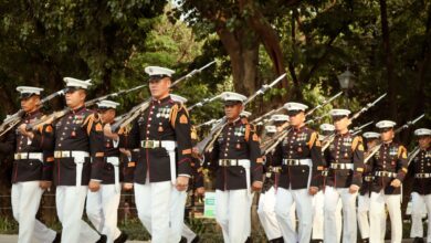 A group of soldiers in formal uniforms marching in a military parade in Manila, Philippines.