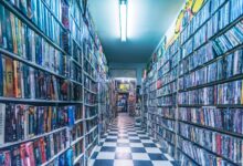 Explore a nostalgic video store aisle filled with classic VHS tapes, capturing retro vibes.
