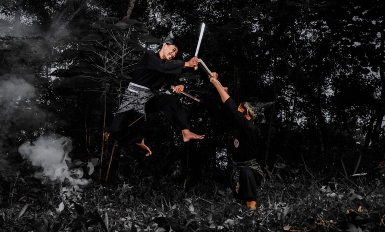 Two martial artists engaged in a high-flying sword fight in a dense forest.