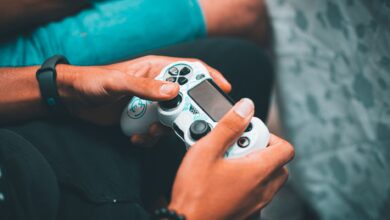 Close-up of hands holding a gaming controller, symbolizing modern gaming culture and leisure.