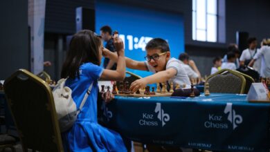 Children enthusiastically engaged in a chess game during a tournament indoors.