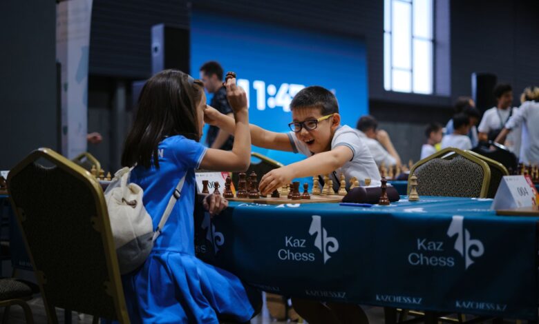 Children enthusiastically engaged in a chess game during a tournament indoors.