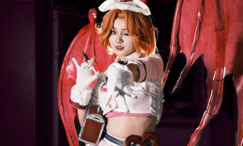 Cosplayer in a demon-themed costume with red wings, posing dramatically. Perfect for fantasy and cosplay themes.