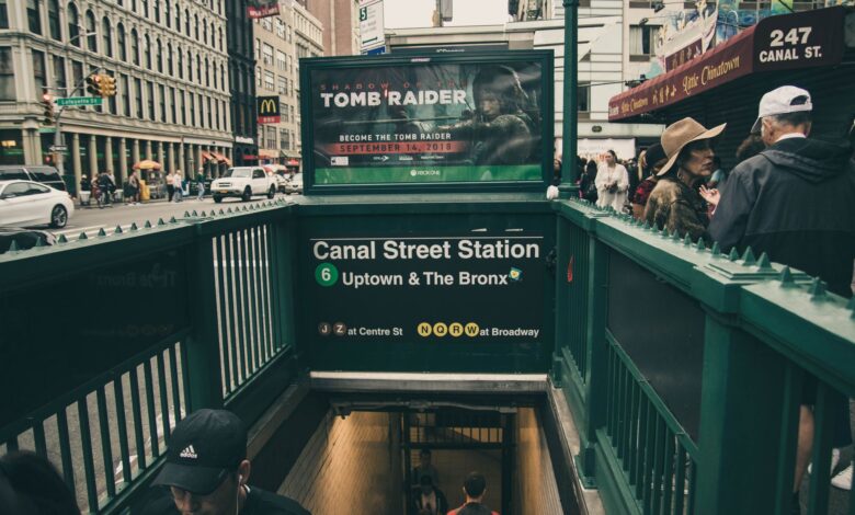 Canal Street Station entrance with urban street scene in New York City.