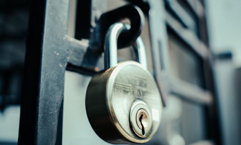 Steel padlock securely fastened on a gate, symbolizing security and protection.