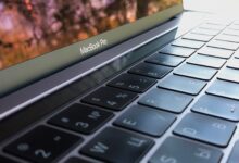 A detailed close-up of a MacBook Pro keyboard, highlighting keys and reflection.