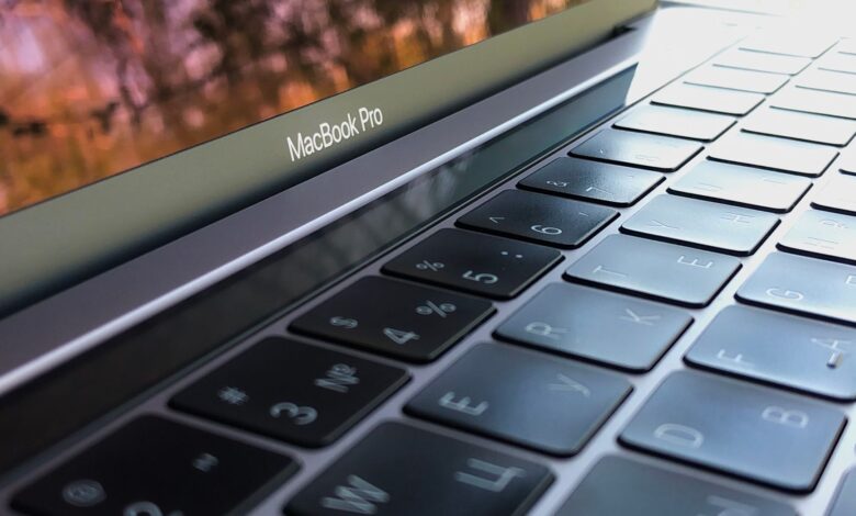 A detailed close-up of a MacBook Pro keyboard, highlighting keys and reflection.
