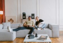 Young couple playing video games in a cozy living room, enjoying a relaxed day indoors.