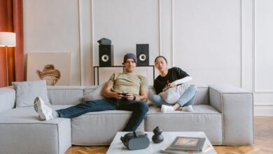 Young couple playing video games in a cozy living room, enjoying a relaxed day indoors.