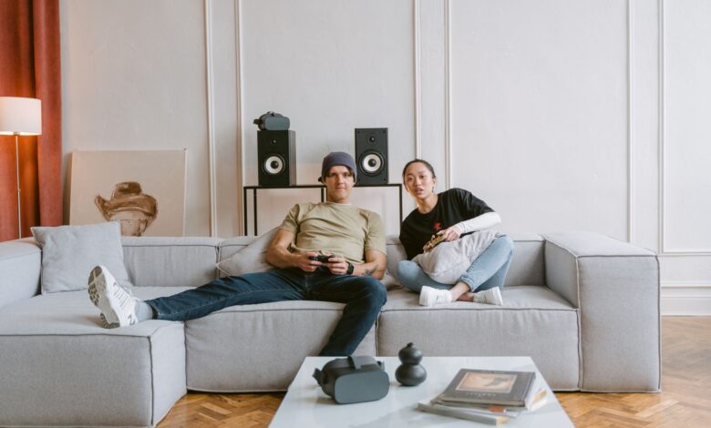 Young couple playing video games in a cozy living room, enjoying a relaxed day indoors.