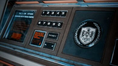Close-up of a vintage arcade machine control panel with numeric keypad and emblem.